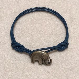 Elephant pendent on blue leather bracelet.